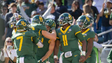 Nov 13, 2021; Waco, Texas, USA; Baylor Bears quarterback Gerry Bohanon (11) and tight end Ben Sims (86) and wide receiver Drew Estrada (18) and running back Abram Smith (7) celebrate a touchdown against the Oklahoma Sooners during the second half at McLane Stadium. Mandatory Credit: Jerome Miron-USA TODAY Sports