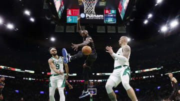 BOSTON, MA - MARCH 30: Derrick White #9 of the Boston Celtics passes past Dewayne Dedmon #21 of the Miami Heat to Daniel Theis under the basket during the second quarter at TD Garden on March 30, 2022 in Boston, Massachusetts. NOTE TO USER: User expressly acknowledges and agrees that, by downloading and/or using this Photograph, user is consenting to the terms and conditions of the Getty Images License Agreement. (Photo By Winslow Townson/Getty Images)