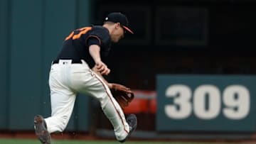 SAN FRANCISCO, CA - AUGUST 19: Kelby Tomlinson (37) of the San Francisco Giants chases after the ball during the second inning against the Philadelphia Phillies at AT