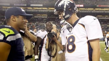 Aug 17, 2013; Seattle, WA, USA; Seattle Seahawks quarterback Russell Wilson (3) and Denver Broncos quarterback Peyton Manning (18) speak following a 40-10 preseason victory by the Seahawks at CenturyLink Field. Mandatory Credit: Joe Nicholson-USA TODAY Sports