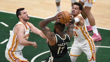 MILWAUKEE, WISCONSIN - JUNE 23: P.J. Tucker #17 of the Milwaukee Bucks is pressured by Trae Young #11 and Danilo Gallinari #8 of the Atlanta Hawks during the third quarter in game one of the Eastern Conference Finals at Fiserv Forum on June 23, 2021 in Milwaukee, Wisconsin. (Photo by Patrick McDermott/Getty Images)