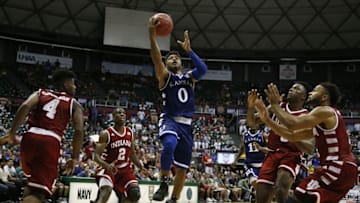 Nov 11, 2016; Honolulu, HI, USA; Kansas Jayhawks guard Frank Mason III (0) lays the ball in against Indiana Hoosiers guard James Blackmon Jr. (1) at the Stan Sheriff Center. Indiana defeats Kansas 103-99 in overtime. Mandatory Credit: Brian Spurlock-USA TODAY Sports