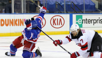 Matt Tennyson #7 of the New Jersey Devils gets the stick up on Brett Howden #21 of the New York Rangers . (Photo by Bruce Bennett/Getty Images)