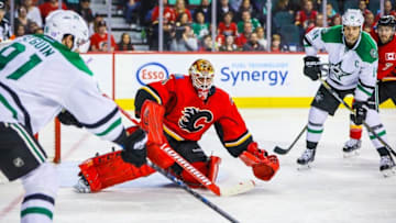 Nov 10, 2016; Calgary, Alberta, CAN; Calgary Flames goalie Brian Elliott (1) guards his net as Dallas Stars left wing Jamie Benn (14) scores a goal during the third period at Scotiabank Saddledome. Dallas Stars won 4-2. Mandatory Credit: Sergei Belski-USA TODAY Sports
