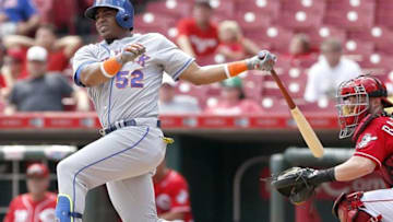 Sep 7, 2016; Cincinnati, OH, USA; New York Mets center fielder Yoenis Cespedes (52) hits an RBI double against the Cincinnati Reds during the ninth inning at Great American Ball Park. The Mets won 6-3. Mandatory Credit: David Kohl-USA TODAY Sports