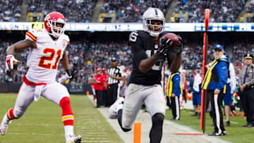 Dec 6, 2015; Oakland, CA, USA; Oakland Raiders wide receiver Michael Crabtree (15) catches the ball but is unable to stay in bounds ahead of Kansas City Chiefs cornerback Sean Smith (21) during the third quarter at O.co Coliseum. Kansas City defeated Oakland 34-20. Mandatory Credit: Kelley L Cox-USA TODAY Sports