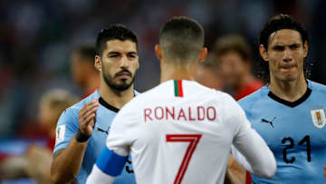 Luis Suarez of Uruguay sahkes hands wuth Cristiano Ronaldo of Portugal. (Photo by Julian Finney/Getty Images)