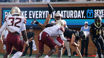Sep 18, 2021; Winston-Salem, North Carolina, USA; Wake Forest Demon Deacons quarterback Sam Hartman (10) dives into the endzone over Florida State Seminoles defensive back Brendan Gant (5) as Seminoles linebacker Stephen Dix Jr. (32) and Demon Deacons running back Justice Ellison (14)n look on during the second half at Truist Field. Mandatory Credit: Reinhold Matay-USA TODAY Sports