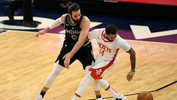MINNEAPOLIS, MINNESOTA - MARCH 26: Ricky Rubio #9 of the Minnesota Timberwolves defends against D.J. Augustin #14 of the Houston Rockets during the fourth quarter of the game at Target Center on March 26, 2021 in Minneapolis, Minnesota. The Timberwolves defeated the Rockets 107-101. NOTE TO USER: User expressly acknowledges and agrees that, by downloading and or using this Photograph, user is consenting to the terms and conditions of the Getty Images License Agreement (Photo by Hannah Foslien/Getty Images)
