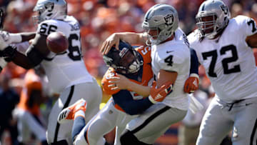 DENVER, CO - SEPTEMBER 16, 2018: Linebacker Von Miller (58) of the Denver Broncos forces a fumble on quarterback Derek Carr (4) of the Oakland Raiders during the first quarter on Sunday, September 16 at Broncos Stadium at Mile High. The ball was recovered by defensive tackle Domata Sr. Peko (94) of the Denver Broncos but the play was called back. The Denver Broncos hosted the Oakland Raiders for the second game of the season. (Photo by Eric Lutzens/The Denver Post via Getty Images)