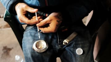 PHILADELPHIA, PA - JANUARY 24: A man uses heroin under a bridge where he lives with other addicts in the Kensington section of Philadelphia which has become a hub for heroin use on January 24, 2018 in Philadelphia, Pennsylvania. Over 900 people died in 2016 in Philadelphia from opioid overdoses, a 30 percent increase from 2015. As the epidemic shows no signs of weakening, the number of fatalities this year is expected to surpass last year's numbers. Heroin use has doubled across the country since 2010, according to the DEA, part of an epidemic. Officials from Philadelphia recently announced that they want to become the first U.S. city to allow supervised drug injection sites as a way to combat the opioid epidemic. (Photo by Spencer Platt/Getty Images)