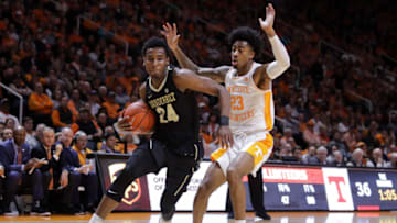 KNOXVILLE, TN - FEBRUARY 19: Aaron Nesmith #24 of the Vanderbilt Commodores drives with the ball past Jordan Bowden #23 of the Tennessee Volunteers during the first half of their game at Thompson-Boling Arena on February 19, 2019 in Knoxville, Tennessee. (Photo by Donald Page/Getty Images)