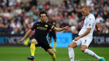 SWANSEA, WALES - SEPTEMBER 24: Swansea player Mike van der Hoorn (r) is challenged by David Silva of Manchester City during the Premier League match between Swansea City and Manchester City at Liberty Stadium on September 24, 2016 in Swansea, Wales. (Photo by Stu Forster/Getty Images)