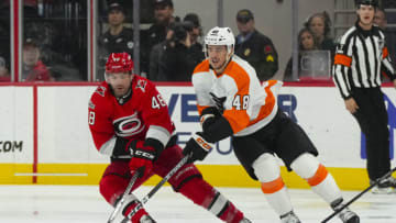 Mar 9, 2023; Raleigh, North Carolina, USA; Philadelphia Flyers left wing Brendan Lemieux (48) skates with the puck against Carolina Hurricanes left wing Jordan Martinook (48) during the second period at PNC Arena. Mandatory Credit: James Guillory-USA TODAY Sports