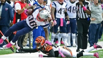 Oct 6, 2013; Cincinnati, OH, USA; New England Patriots running back Brandon Bolden (38) gets pushed out of bounds by Cincinnati Bengals cornerback Terence Newman (23) in the first half of the game at Paul Brown Stadium. Mandatory Credit: Marc Lebryk-USA TODAY Sports