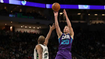 MILWAUKEE, WISCONSIN - DECEMBER 01: Gordon Hayward #20 of the Charlotte Hornets shoots over Khris Middleton #22 of the Milwaukee Bucks during a game at Fiserv Forum on December 01, 2021 in Milwaukee, Wisconsin. NOTE TO USER: User expressly acknowledges and agrees that, by downloading and or using this photograph, User is consenting to the terms and conditions of the Getty Images License Agreement. (Photo by Stacy Revere/Getty Images)