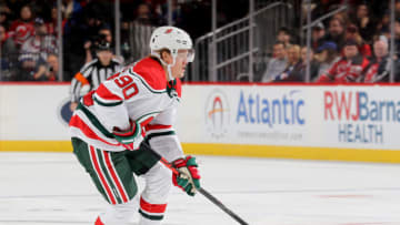 NEWARK, NEW JERSEY - NOVEMBER 30: Jesper Boqvist #90 of the New Jersey Devils takes the puck in the second period against the New York Rangers at Prudential Center on November 30, 2019 in Newark, New Jersey. (Photo by Elsa/Getty Images)