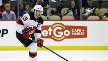 Feb 24, 2022; Pittsburgh, Pennsylvania, USA; New Jersey Devils center Nico Hischier (13) skates with he puck against the Pittsburgh Penguins during the third period at PPG Paints Arena. The Devils won 6-1. Mandatory Credit: Charles LeClaire-USA TODAY Sports