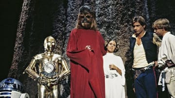 (L to r) R2-D2, Anthony Daniels as C-3PO, Peter Mayhew as Chewbacca, Carrie Fisher as Princess Leia, Harrison Ford as Han Solo, and Mark Hamill as Luke Skywalker in the Star Wars Holiday Special