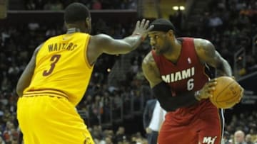 Mar 18, 2014; Cleveland, OH, USA; Miami Heat forward LeBron James (6) holds the ball against Cleveland Cavaliers guard Dion Waiters (3) in the second quarter at Quicken Loans Arena. Mandatory Credit: David Richard-USA TODAY Sports