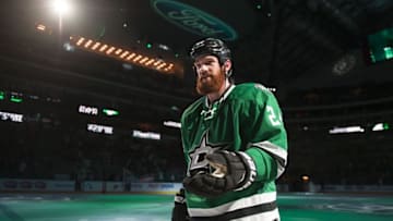 Apr 7, 2016; Dallas, TX, USA; Dallas Stars defenseman Jordie Benn (24) throws a puck into the stands after the game against the Colorado Avalanche at the American Airlines Center. The Stars won 4-2. Mandatory Credit: Jerome Miron-USA TODAY Sports