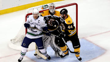 BOSTON, MA - JUNE 08: Henrik Sedin #33 of the Vancouver Canucks against Dennis Seidenberg #44 and Tim Thomas #30 of the Boston Bruins during Game Four of the 2011 NHL Stanley Cup Final at TD Garden on June 8, 2011 in Boston, Massachusetts. (Photo by Jim Rogash/Getty Images)