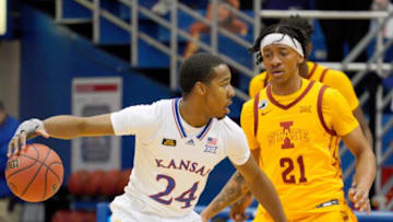 Feb 11, 2021; Lawrence, Kansas, USA; Kansas Jayhawks guard Bryce Thompson (24) dribbles the ball as Iowa State Cyclones guard Jaden Walker (21) defends during the game at Allen Fieldhouse. Mandatory Credit: Denny Medley-USA TODAY Sports