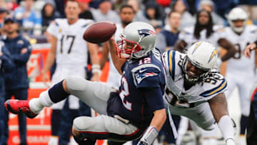 FOXBORO, MA - OCTOBER 29: Tom Brady #12 of the New England Patriots is tackled by Darius Philon #93 of the Los Angeles Chargers during the fourth quarter of a game at Gillette Stadium on October 29, 2017 in Foxboro, Massachusetts. (Photo by Jim Rogash/Getty Images)
