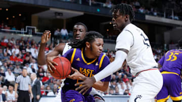 HIGHLAND HEIGHTS, KY - JANUARY 20: Shawn Williams #55 of the East Carolina Pirates tries to get rid of the ball while defended by Tre Scott #13 of the Cincinnati Bearcats in the second half of a game at BB&T Arena on January 20, 2018 in Highland Heights, Kentucky. Cincinnati won 86-60. (Photo by Joe Robbins/Getty Images)