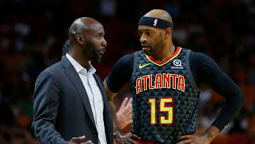 MIAMI, FLORIDA - OCTOBER 14: Head coach Lloyd Pierce of the Atlanta Hawks talks with Vince Carter #15 against the Miami Heat during the first half of the preseason game at American Airlines Arena on October 14, 2019 in Miami, Florida. NOTE TO USER: User expressly acknowledges and agrees that, by downloading and or using this photograph, User is consenting to the terms and conditions of the Getty Images License Agreement. (Photo by Michael Reaves/Getty Images)