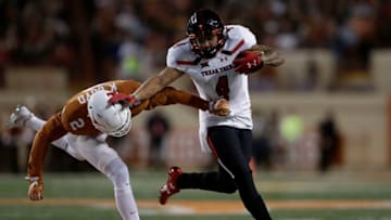AUSTIN, TX - NOVEMBER 24: Justin Stockton #4 of the Texas Tech Red Raiders gives a stiff arm to Kris Boyd #2 of the Texas Longhorns in the third quarter at Darrell K Royal-Texas Memorial Stadium on November 24, 2017 in Austin, Texas. (Photo by Tim Warner/Getty Images)