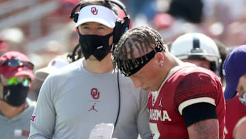 Sep 26, 2020; Norman, Oklahoma, USA; Oklahoma Sooners quarterback Spencer Rattler (7) speaks with head coach Lincoln Riley during the second half against the Kansas State Wildcats at Gaylord Family Oklahoma Memorial Stadium. Mandatory Credit: Kevin Jairaj-USA TODAY Sports