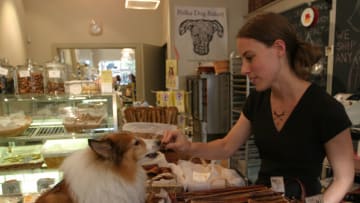 Polka Dog Bakery co-owner and biscuit baker Deborah Gregg helps a customer with a treat. The boutique was created to produce all-natural gourmet dog treats for local pets. (Photo by Rick Friedman/Corbis via Getty Images)