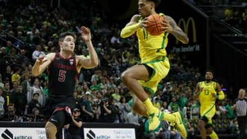 Oregon guard Rivaldo Soares leaps past a pair of defenders as the Oregon Ducks host the Stanford Cardinal Saturday, March 4, 2023 at Matthew Knight Arena in Eugene, Ore.Ncaa Basketball Stanford At Oregon Mbb Stanford At Oregon