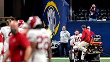 Dec 19, 2020; Atlanta, Georgia, USA; Alabama Crimson Tide offensive lineman Landon Dickerson (69) is taken off the field after an injury during the fourth quarter against the Florida Gators in the SEC Championship at Mercedes-Benz Stadium. Mandatory Credit: Dale Zanine-USA TODAY Sports