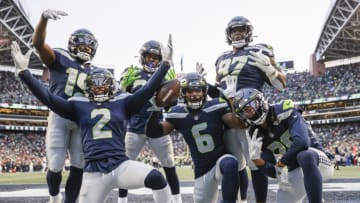 SEATTLE, WASHINGTON - DECEMBER 05: Quandre Diggs #6 of the Seattle Seahawks celebrates an interception with teammates during the third quarter against the San Francisco 49ers at Lumen Field on December 05, 2021 in Seattle, Washington. The interception was later ruled by officials as an incomplete pass. (Photo by Steph Chambers/Getty Images)