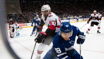 TORONTO, ON - SEPTEMBER 19: Ben Smith #18 of the Toronto Maple Leafs and Ben Harpur #67 of the Ottawa Senators head into the corner during the first period at the Air Canada Centre in their preseason hockey game on September 19, 2017 in Toronto, Ontario, Canada. (Photo by Mark Blinch/NHLI via Getty Images)