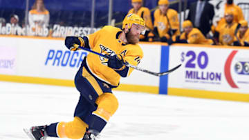 Mar 30, 2021; Nashville, Tennessee, USA; Nashville Predators defenseman Mattias Ekholm (14) shoots the puck against the Dallas Stars during the first period at Bridgestone Arena. Mandatory Credit: Christopher Hanewinckel-USA TODAY Sports