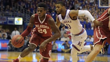 Jan 4, 2016; Lawrence, KS, USA; Oklahoma Sooners guard Buddy Hield (24) moves the ball against Kansas Jayhawks guard Frank Mason III (0) in the first half at Allen Fieldhouse. Mandatory Credit: John Rieger-USA TODAY Sports