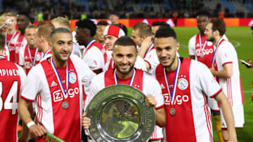 DOETINCHEM, NETHERLANDS - MAY 15: (L-R) Hakim Ziyech of Ajax, Zakaria Labyad of Ajax and Noussair Mazraoui of Ajax celebrate with the trophy after winning the Eredivisie following the Eredivisie match between De Graafschap and Ajax at Stadion De Vijverberg on May 15, 2019 in Doetinchem, Netherlands. (Photo by Dean Mouhtaropoulos/Getty Images)