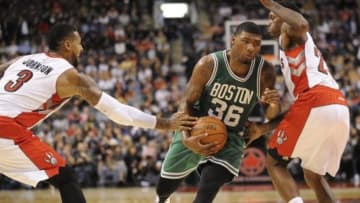 Oct 10, 2014; Toronto, Ontario, CAN; Boston Celtics guard Marcus Smart (36) makes a move between Toronto Raptors forward James Johnson (3) and guard Louis Williams (23) in the fourth quarter at Air Canada Centre. Raptors won 116-109. Mandatory Credit: Peter Llewellyn-USA TODAY Sports