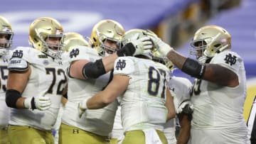 Oct 24, 2020; Pittsburgh, Pennsylvania, USA; Teammates congratulate Notre Dame Fighting Irish tight end Michael Mayer (87) on his touchdown against the Pittsburgh Panthers during the third quarter at Heinz Field. The Irish won 45-3. Mandatory Credit: Charles LeClaire-USA TODAY Sports