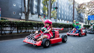 TOKYO, JAPAN - NOVEMBER 16: Participants drive around Tokyo for the Real Mario Kart event in Tokyo on November 16, 2014 in Tokyo, Japan. The organizer calls for participants to this event held about once a month on Facebook, and Akiba Kart offers rental karts that can be driven on public streets. (Photo by Keith Tsuji/Getty Images)