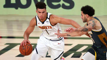 LAKE BUENA VISTA, FLORIDA - AUGUST 03: Michael Porter Jr. #1 of the Denver Nuggets handles the ball against Abdel Nader #11 of the Oklahoma City Thunder in the first half at The Arena at ESPN Wide World Of Sports Complex on August 3, 2020 in Lake Buena Vista, Florida. NOTE TO USER: User expressly acknowledges and agrees that, by downloading and or using this photograph, User is consenting to the terms and conditions of the Getty Images License Agreement. (Photo by Kim Klement-Pool/Getty Images)