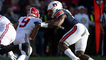 Auburn football defensive lineman T.D. Moultry (99) sacs Alabama quarterback Bryce Young (9) during the Iron Bowl at Jordan-Hare Stadium in Auburn, Ala., on Saturday, Nov. 27, 2021.Ncaa Football Alabamaat Auburn