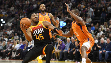 SALT LAKE CITY, UTAH - APRIL 08: Donovan Mitchell #45 of the Utah Jazz drives around Chris Paul #3 of the Phoenix Suns during the second half of a game at Vivint Smart Home Arena on April 08, 2022 in Salt Lake City, Utah. NOTE TO USER: User expressly acknowledges and agrees that, by downloading and or using this photograph, User is consenting to the terms and conditions of the Getty Images License Agreement. (Photo by Alex Goodlett/Getty Images)