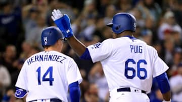 LOS ANGELES, CA - MAY 25: Yasiel Puig #66 and Enrique Hernandez #14 of the Los Angeles Dodgers celebrate their runs off of a Kenta Maeda #18 single to take a 4-3 lead over the St. Louis Cardinals during the fourth inning at Dodger Stadium on May 25, 2017 in Los Angeles, California. (Photo by Harry How/Getty Images)