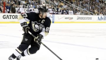 Apr 26, 2014; Pittsburgh, PA, USA; Pittsburgh Penguins center Sidney Crosby (87) chases the puck against the Columbus Blue Jackets during the third period in game five of the first round of the 2014 Stanley Cup Playoffs at the CONSOL Energy Center. The Penguins won 3-1. Mandatory Credit: Charles LeClaire-USA TODAY Sports
