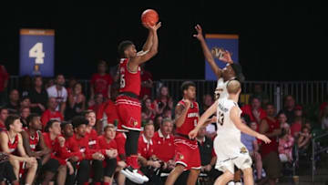 Nov 24, 2016; Paradise Island, BAHAMAS; Louisville Cardinals guard Donovan Mitchell (45) shoots over Wichita State Shockers forward Markis McDuffie (32) during the second half in the 2016 Battle 4 Atlantis in the Imperial Arena at the Atlantis Resort. Mandatory Credit: Kevin Jairaj-USA TODAY Sports