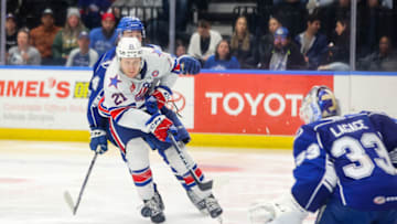 SYRACUSE, NY - APRIL 22: Kohen Olischefski #21 of Rochester Americans attempts a shot on goal against Max Lagace #33 of Syracuse Crunch during Game 2 of the north division semifinals of the Calder Cup Playoffs at Upstate Medical University Arena on April 22, 2023 in Syracuse, New York. (Photo by Isaiah Vazquez/Getty Images)